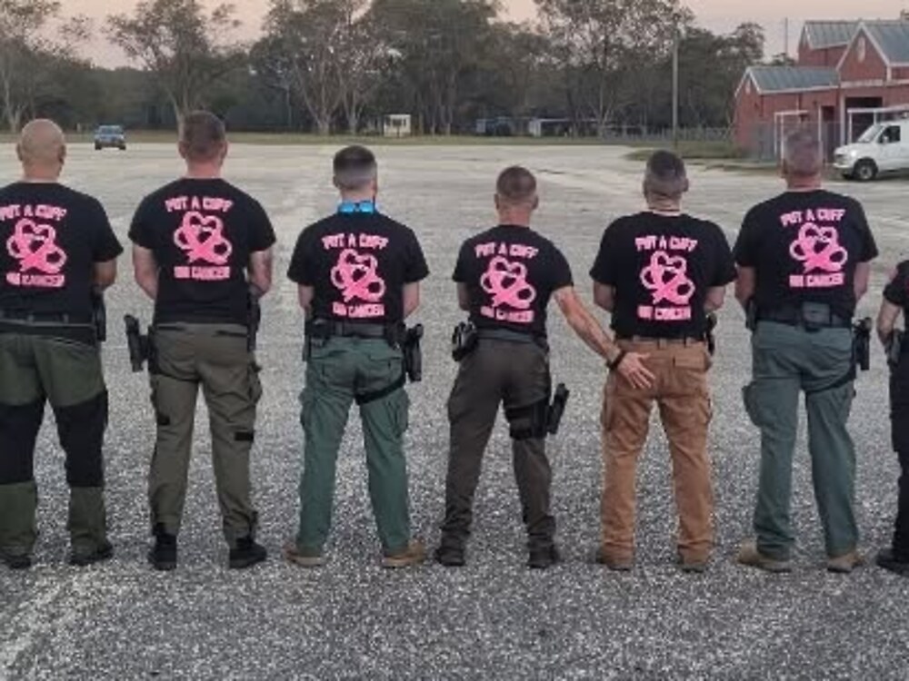 Deputies in pink Put a Cuff on Cancer shirts, seen from behind