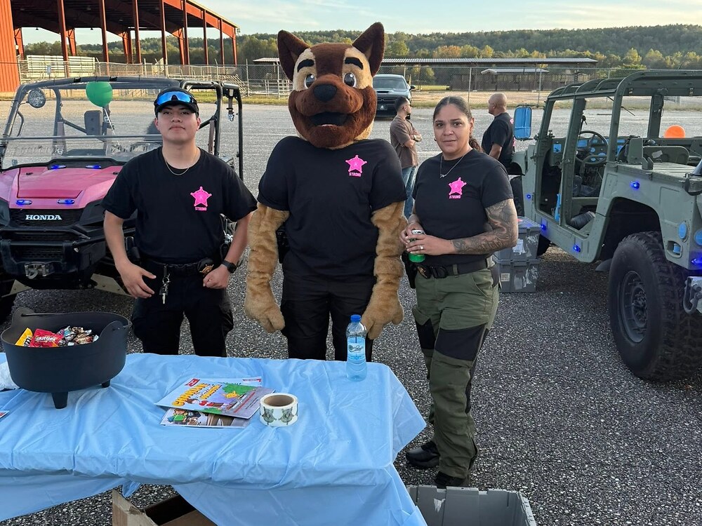 Deputies and the Sheriff's Office K9 mascot at a Trunk or Treat candy table